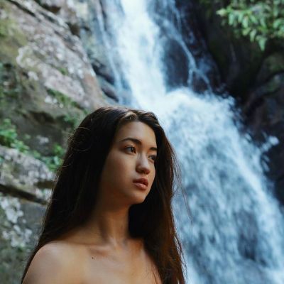 Reina Hardesty is clicking a photo near a rainfall.